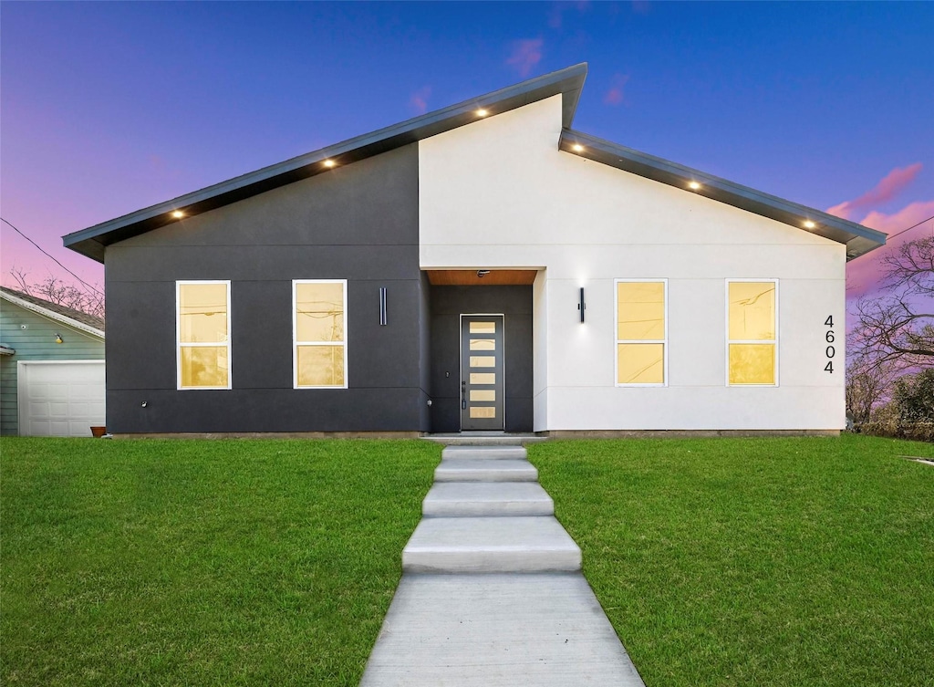 modern home with a garage and a lawn