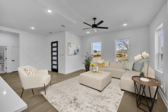 living room with dark wood-type flooring and ceiling fan