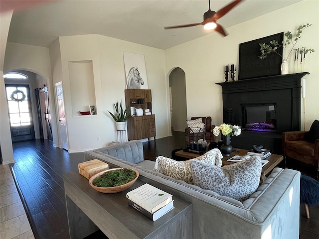 living room featuring hardwood / wood-style floors and ceiling fan