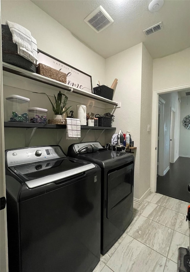 washroom featuring washing machine and dryer