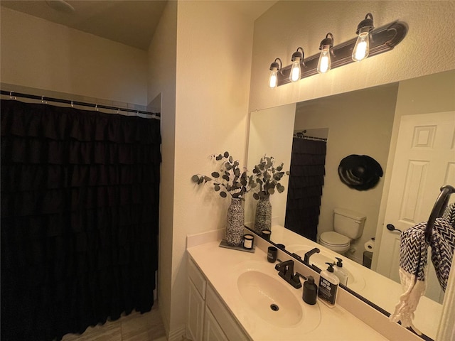 bathroom with vanity, a shower with curtain, and toilet