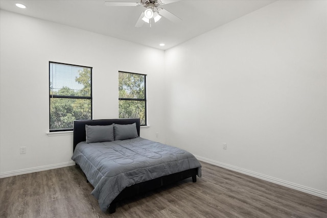 bedroom with ceiling fan and dark hardwood / wood-style flooring