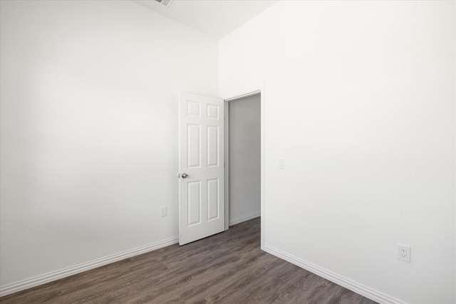 unfurnished room with dark hardwood / wood-style floors