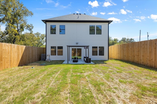 rear view of house with a patio, central AC unit, and a lawn