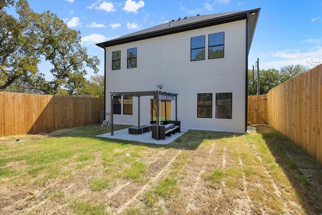 back of house with a pergola, an outdoor hangout area, a patio, and a lawn