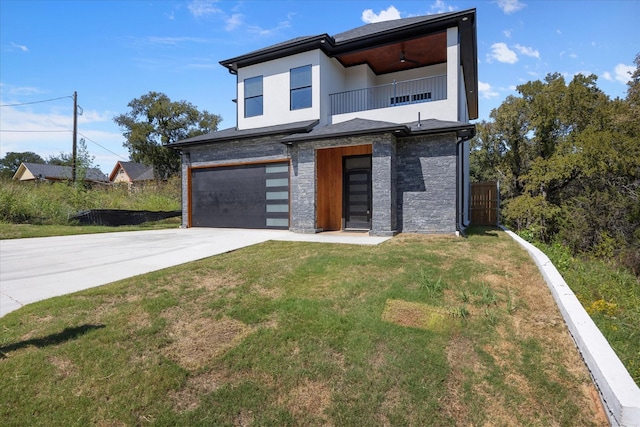 modern home with a garage, a balcony, and a front yard