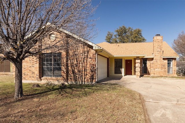 ranch-style home with a garage and a front lawn