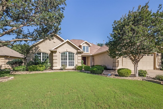 9704 Freeport Dr, Denton, TX 76207 - view of front facade featuring a front lawn, driveway, stucco siding, and an attached garage
