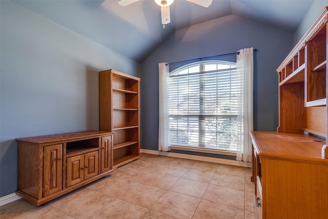 unfurnished office with lofted ceiling, light tile patterned floors, and ceiling fan