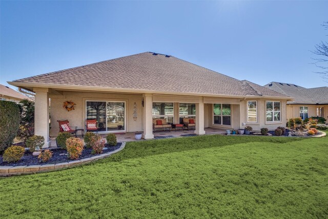 rear view of house featuring a patio area and a lawn