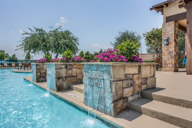 view of swimming pool featuring pool water feature