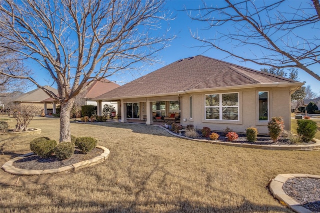 rear view of property with a lawn