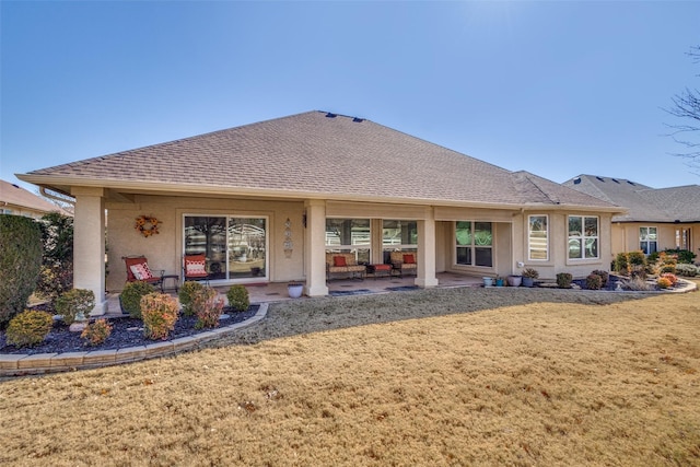 back of property featuring a patio area and a lawn