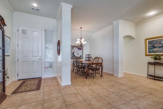 entryway with lofted ceiling, light tile patterned floors, and ornamental molding