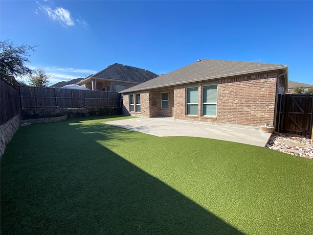 back of property with a patio and a yard