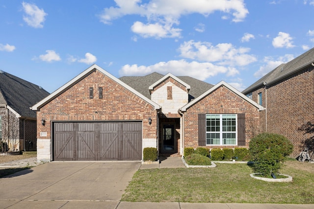 view of property featuring a garage and a front lawn