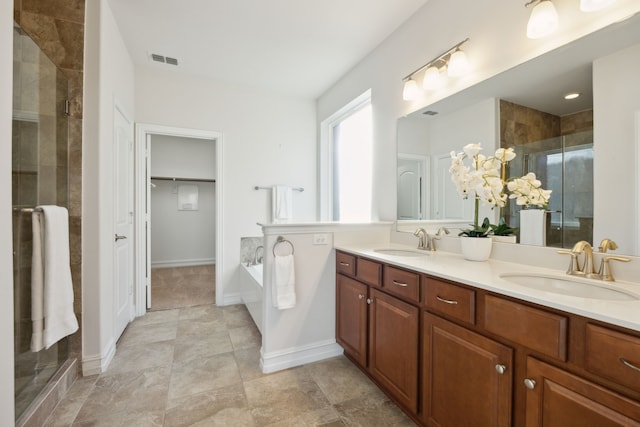 bathroom with vanity and a shower with shower door