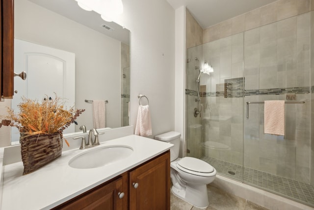 bathroom with vanity, tile patterned floors, toilet, and walk in shower