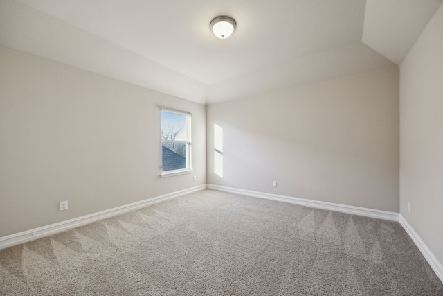 unfurnished room with lofted ceiling and carpet floors