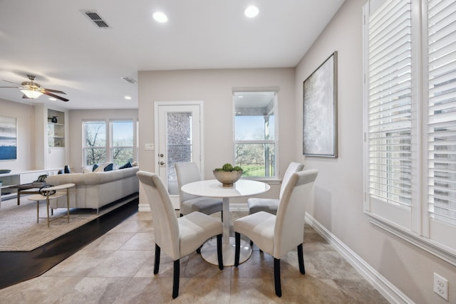 tiled dining space featuring ceiling fan