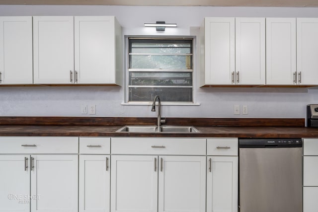 kitchen featuring white cabinetry, sink, dishwasher, and butcher block countertops