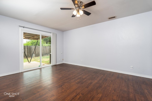 empty room with ceiling fan and dark hardwood / wood-style flooring