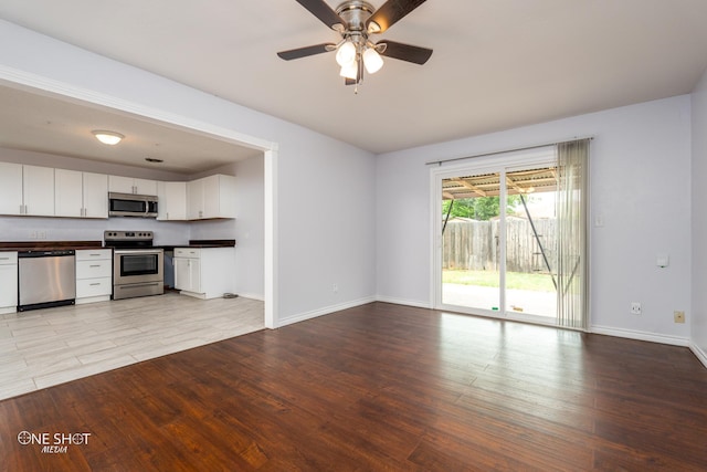 unfurnished living room featuring ceiling fan and light hardwood / wood-style flooring