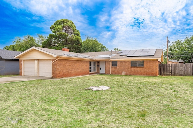 single story home with a garage, a front lawn, and solar panels