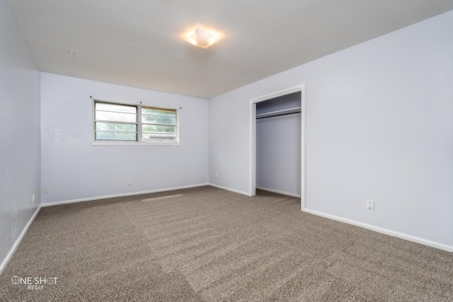 unfurnished bedroom with carpet and a closet