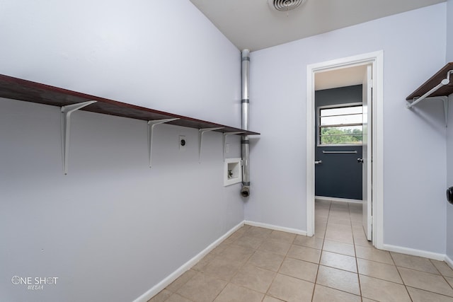 laundry area featuring light tile patterned flooring, hookup for an electric dryer, and hookup for a washing machine