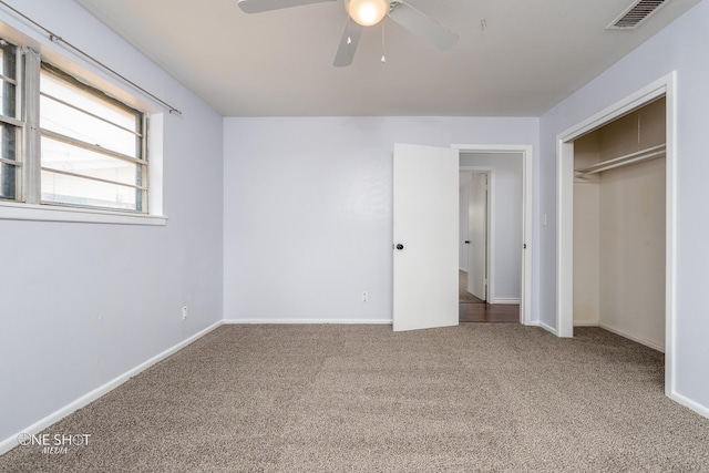 unfurnished bedroom featuring a closet, ceiling fan, and carpet