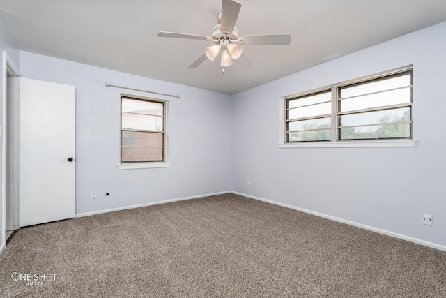 empty room with ceiling fan and carpet flooring