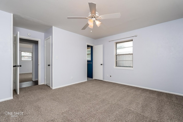 unfurnished bedroom featuring ceiling fan and carpet