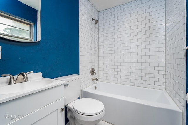 full bathroom featuring vanity, tiled shower / bath combo, and toilet