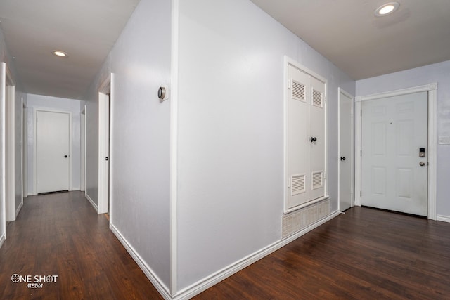 hallway with dark hardwood / wood-style flooring