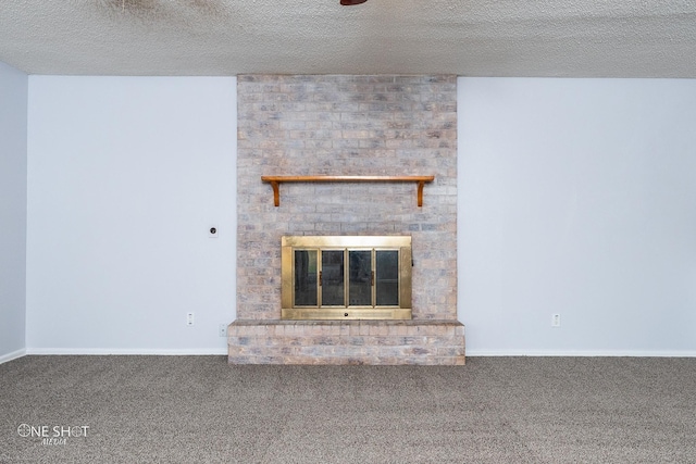 unfurnished living room featuring a fireplace, carpet flooring, and a textured ceiling