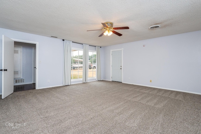 empty room with ceiling fan, a textured ceiling, and carpet flooring