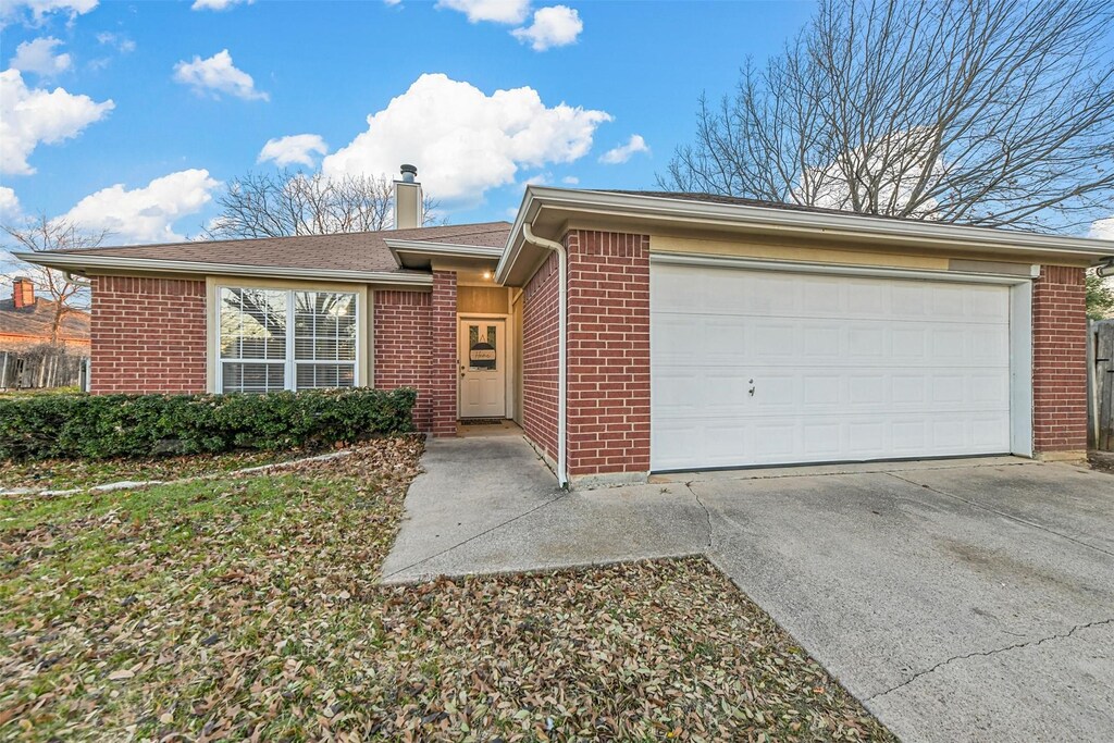 single story home with a garage and a lawn