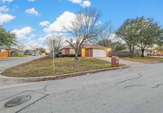 single story home featuring a garage and a front yard