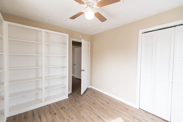 unfurnished bedroom featuring ceiling fan, a closet, and light hardwood / wood-style flooring