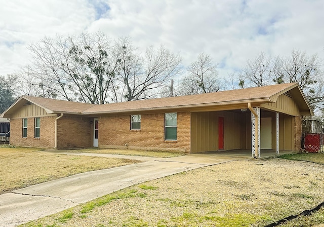 ranch-style house featuring a carport and a front lawn