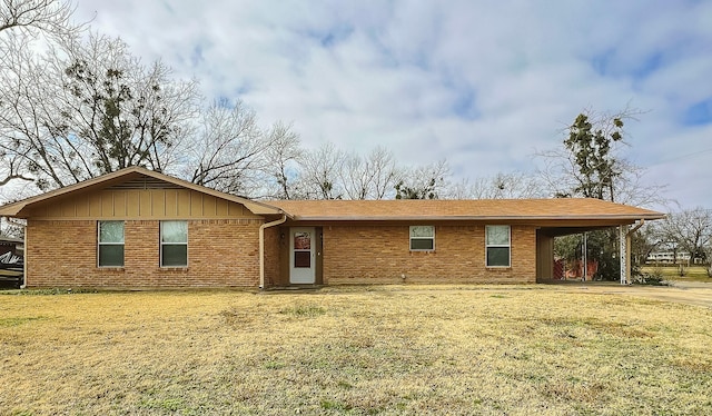 view of front of house with a front yard and a carport