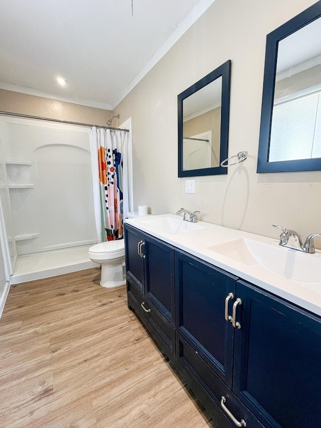 bathroom featuring toilet, crown molding, vanity, a shower with shower curtain, and hardwood / wood-style flooring