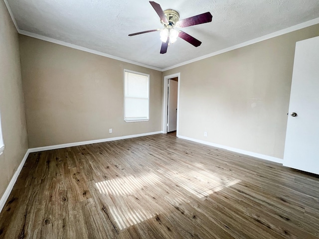 unfurnished room featuring hardwood / wood-style floors, a textured ceiling, ornamental molding, and ceiling fan