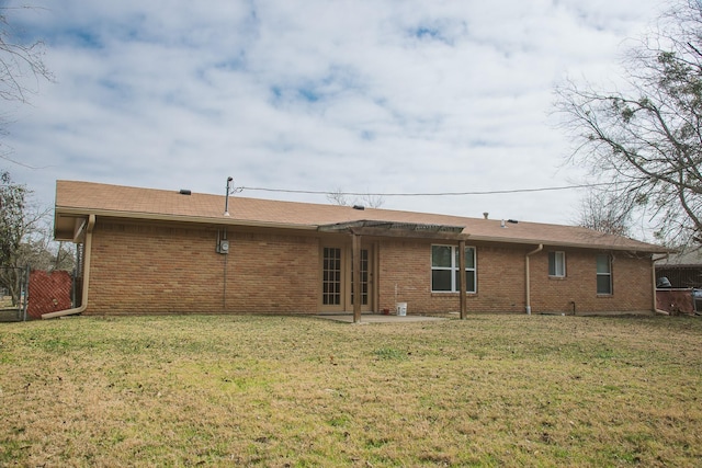 rear view of property featuring a yard and a patio