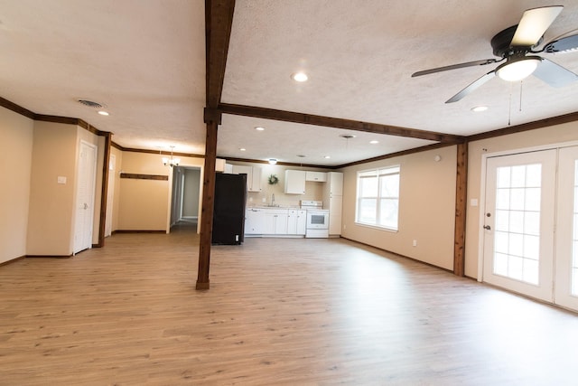 unfurnished living room with ornamental molding, light hardwood / wood-style floors, and ceiling fan