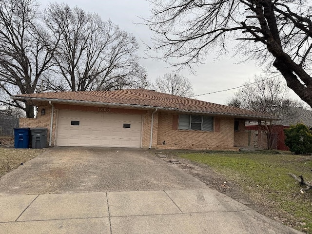 ranch-style house featuring a garage and a front yard