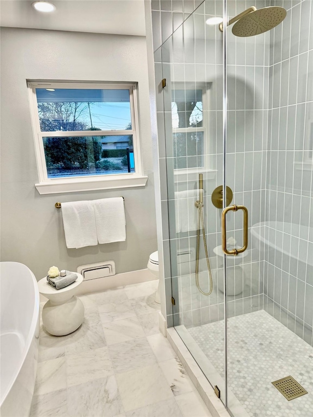 bathroom with a shower with door and toilet