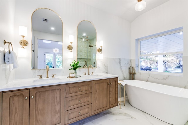 bathroom featuring vanity, shower with separate bathtub, and tile walls