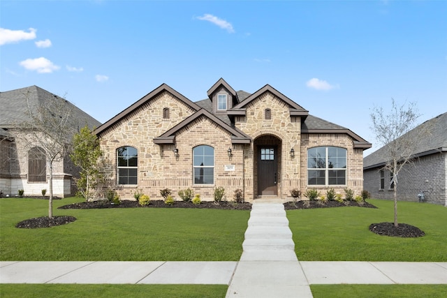 french country home featuring a front yard